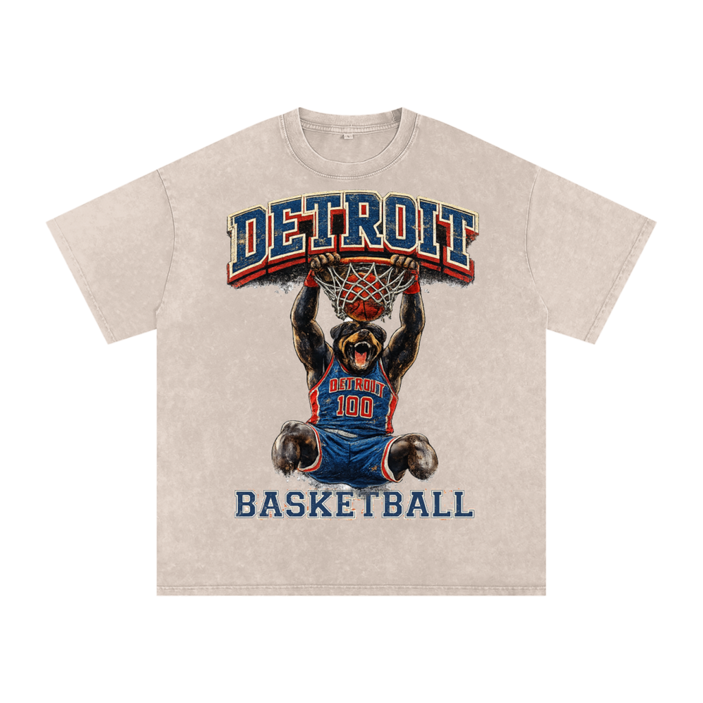 Beige t-shirt with a graphic of a bear playing basketball and 'Detroit Basketball' text on a white background. Detroit Pistons Gear.
